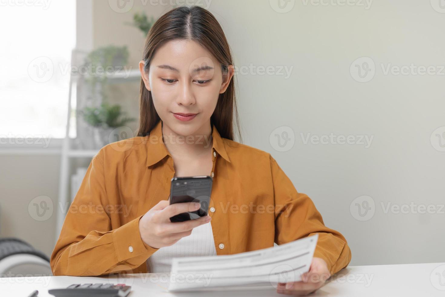 Convenience online internet banking, asian young woman hand in payment bill, spending by scan qr code, use phone, mobile to transfer or pay money of credit card without cash. Technology of financial. photo