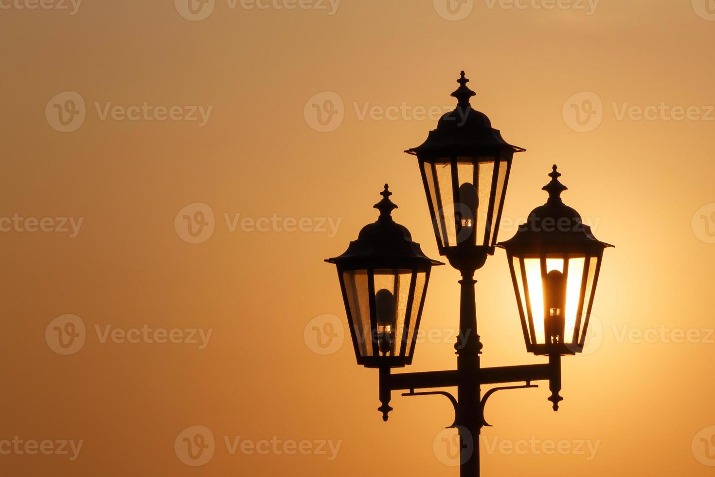 silhouette of lantern against rising sun in Odesa photo