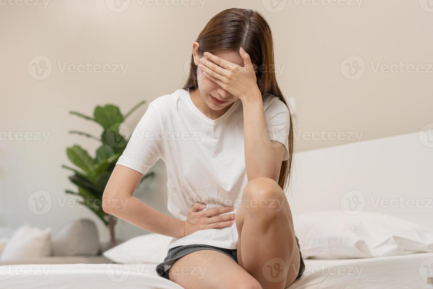 Flatulence ulcer, asian young woman, girl hands in belly, stomachache from food poisoning, abdominal pain and digestive problem, gastritis or diarrhoea. Abdomen inflammation, menstrual period people. photo