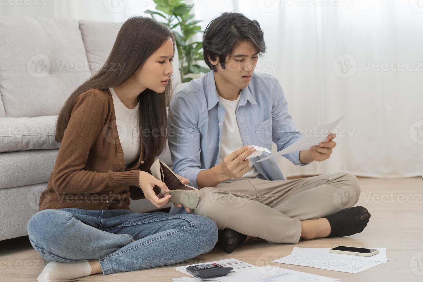 Stressed financial owe asian young couple love sitting suffer, stressed and confused by calculate expense from invoice or bill, no money to pay, mortgage or loan. Debt, bankrupt or bankruptcy people. photo