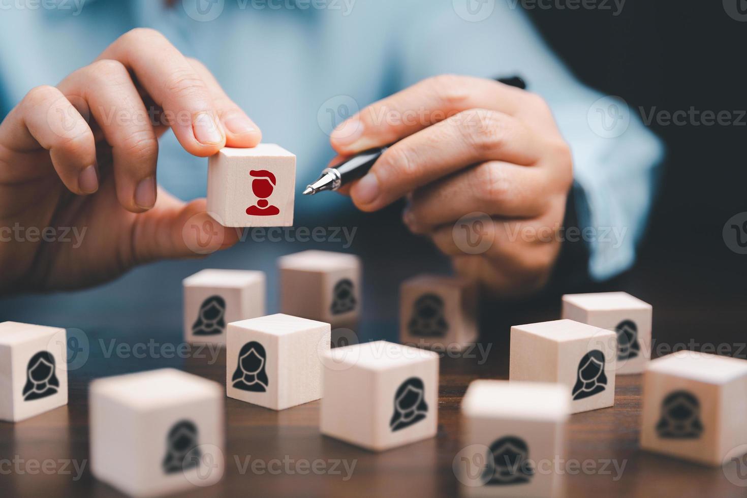 Manager chooses and hiring team for business success. HR manager hand or Employer chooses takes in hand employee. Leader stands out from crowd. Looking for good worker. HR, HRM, HRD concepts photo