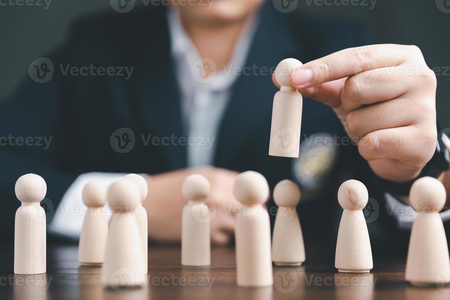 Manager chooses and hiring team for business success. HR manager hand or Employer chooses takes in hand employee. Leader stands out from crowd. Looking for good worker. HR, HRM, HRD concepts photo