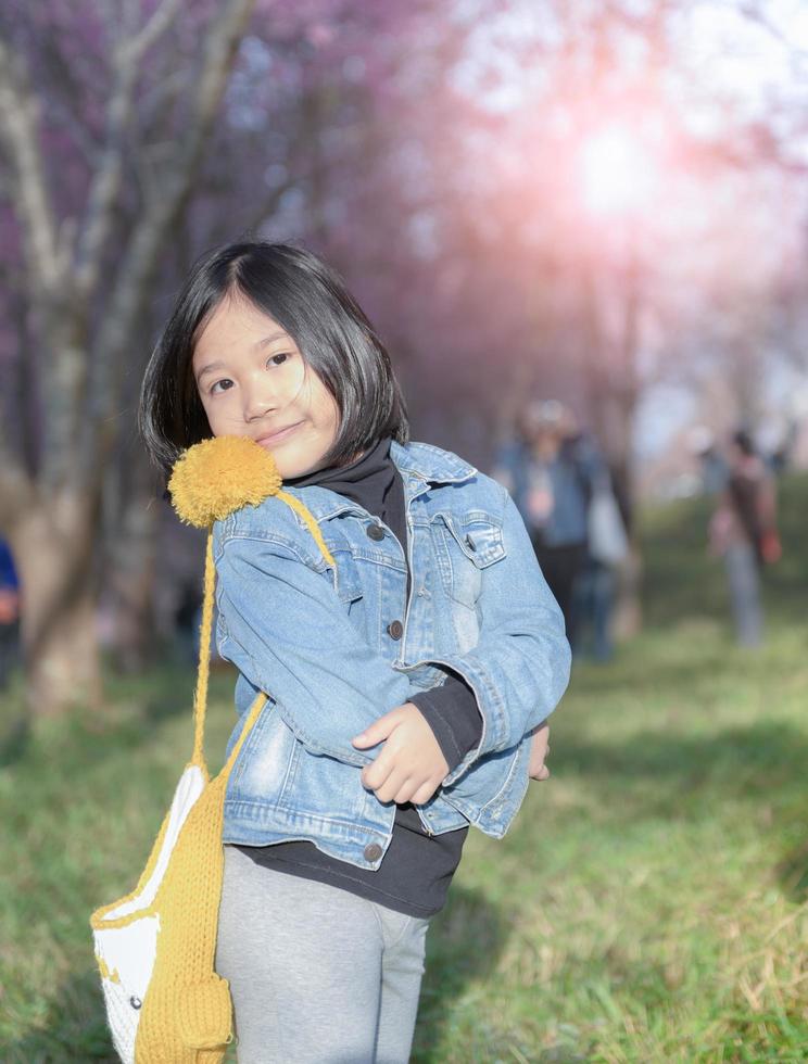 Happy traveler girl smile on cherry blossom background, photo