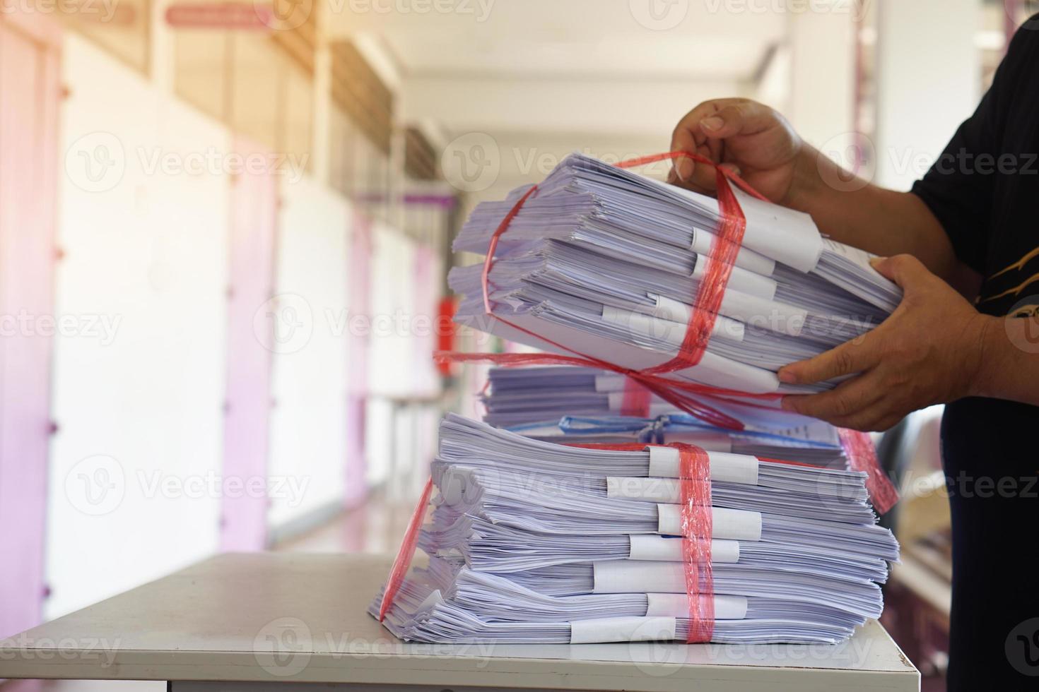 Closeup hands hold stack of used paper, combine to use next time or take to recycle process. Concept, eco friendly activity. Waste paper management. Reduce reuse, recycle paper. photo