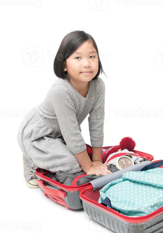 cute asian girl packing suitcases preparing for travel trip isolated photo