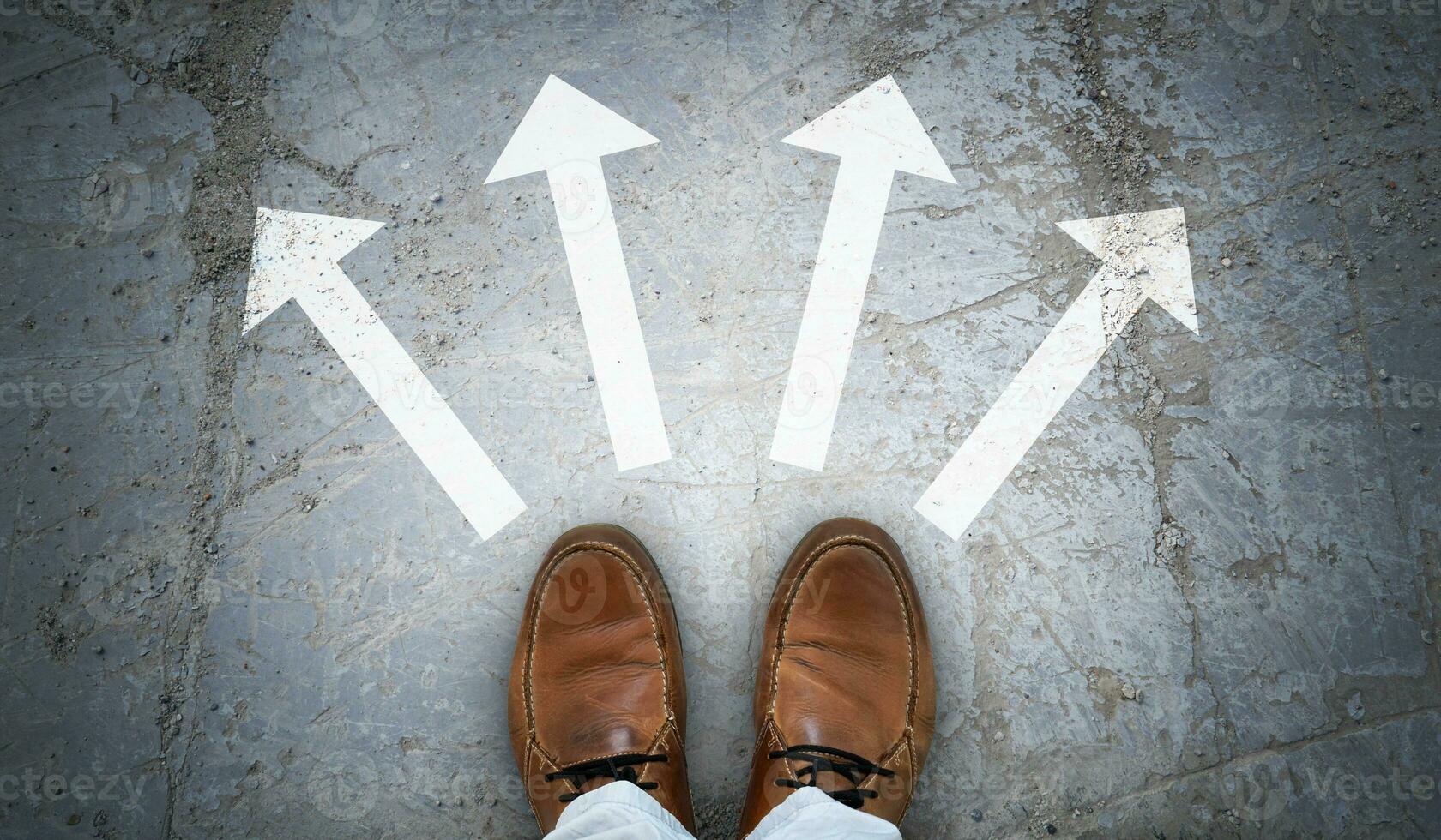 Brown Leather Shoes and Four Chalky Arrows on Asphalt - Choice Concept photo