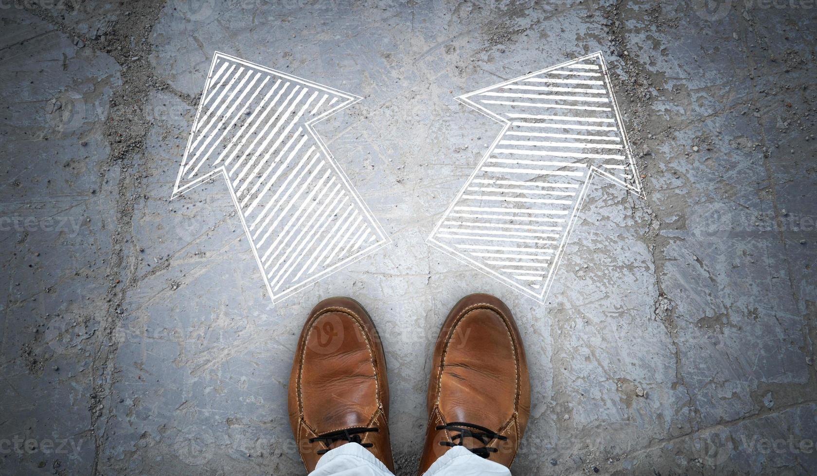 Brown Leather Shoes and Two Right and Left Chalky Arrows on Asphalt - Choice Concept photo