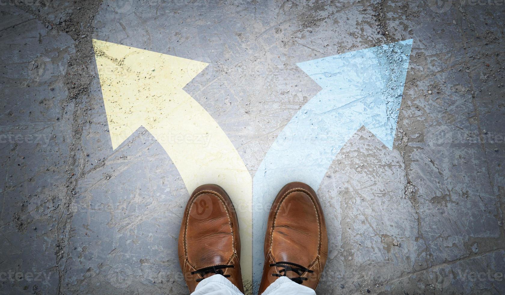 Brown Leather Shoes and Two Colorful Chalky Arrows on Asphalt - Choice Concept photo