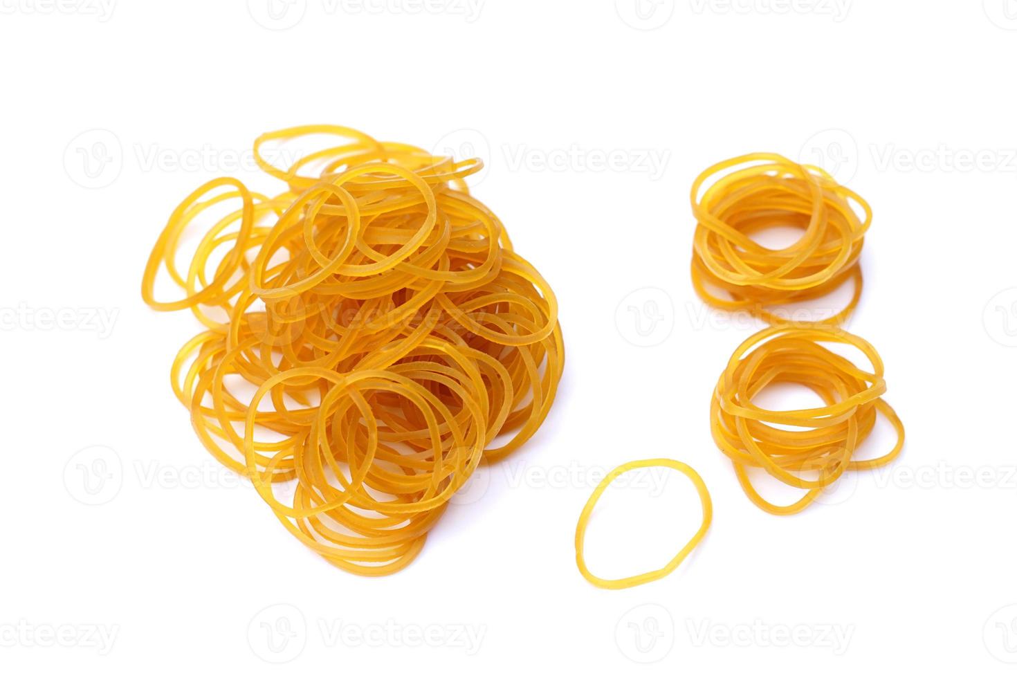 Brown rubber bands isolated on white background. Concept, equipment for fasten, tie general things, bind small objects together,made from natural para rubber. Sticky, flexibility,  used for versatile. photo