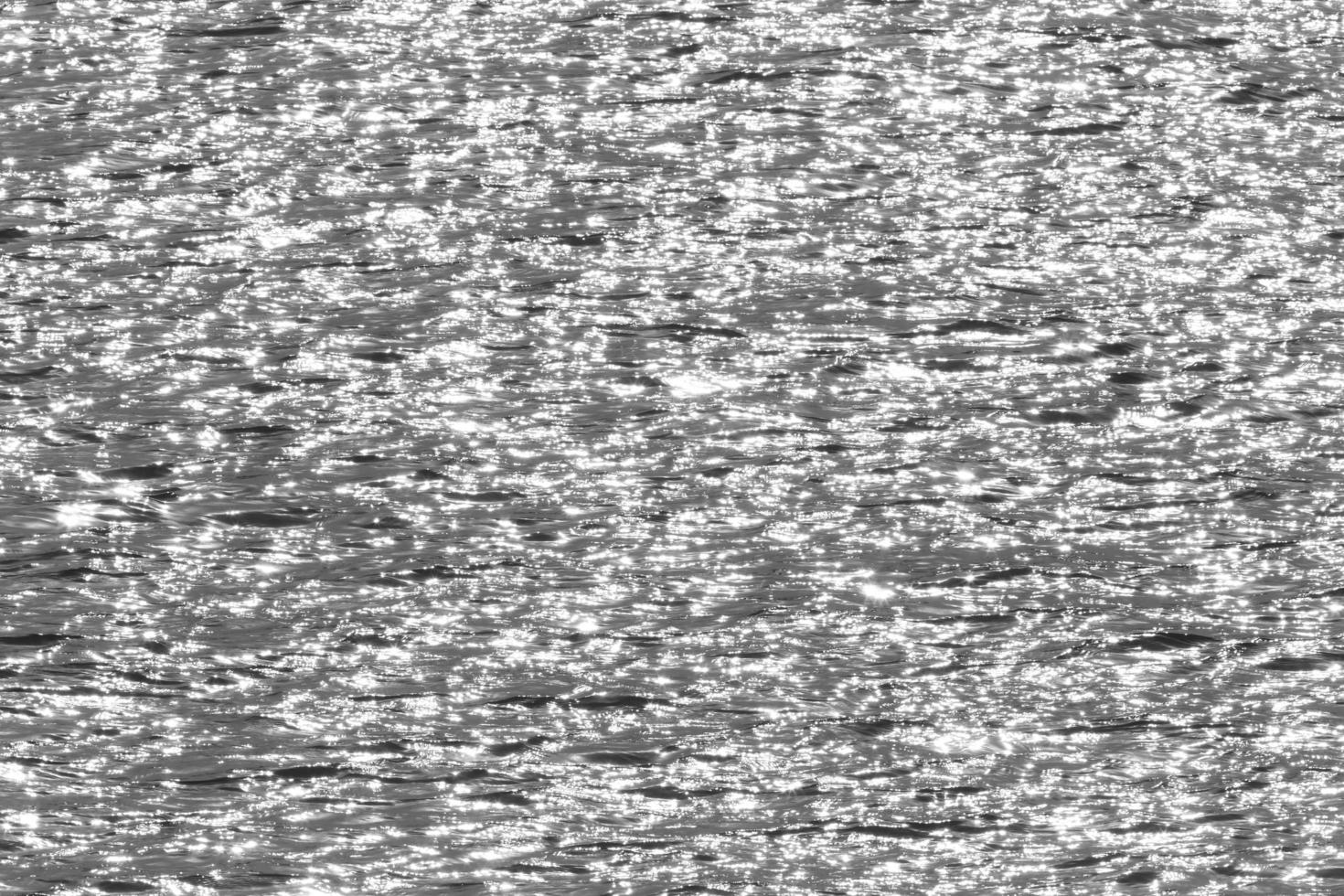 black and white photo of sunshine in waves of river