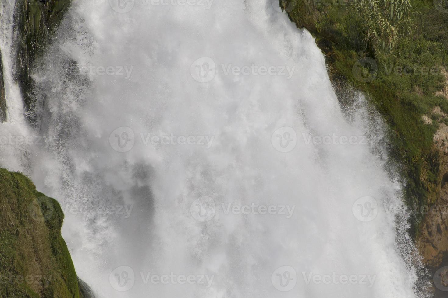 view on huge srtream of water in waterfall photo