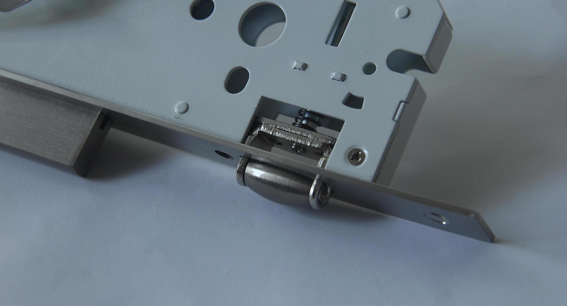 Stainless steel door lock case body mechanism. Safety and privacy themed photo isolated on plain white background. Pelor latch lock case.