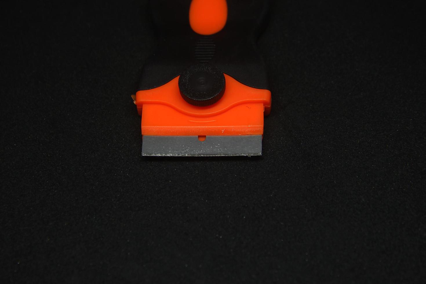 Small sharp iron metal scraper must have floor home house cleaning item. Small knife to clean paint or cement dirt drop on the floor. photo