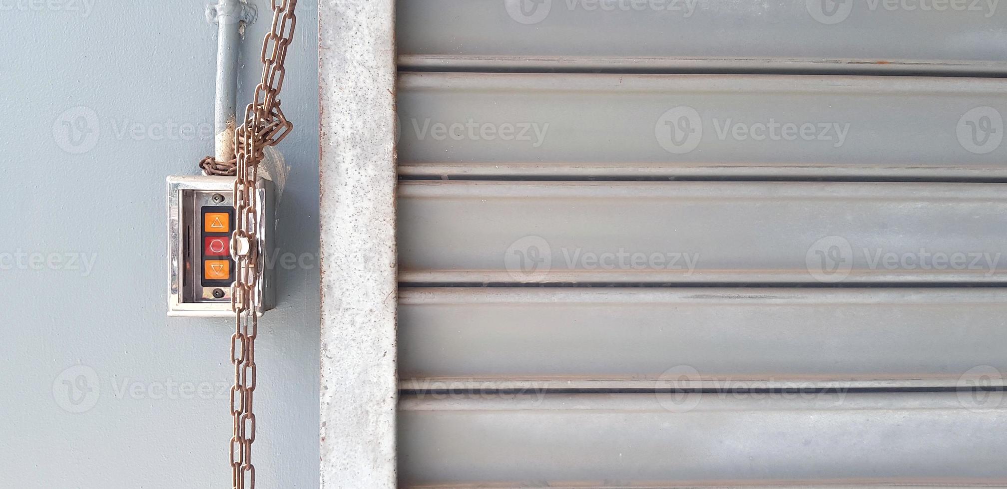 Red and orange button with chain for open and closed steel shutter door in cargo terminal. Object, Technology and Background concept photo