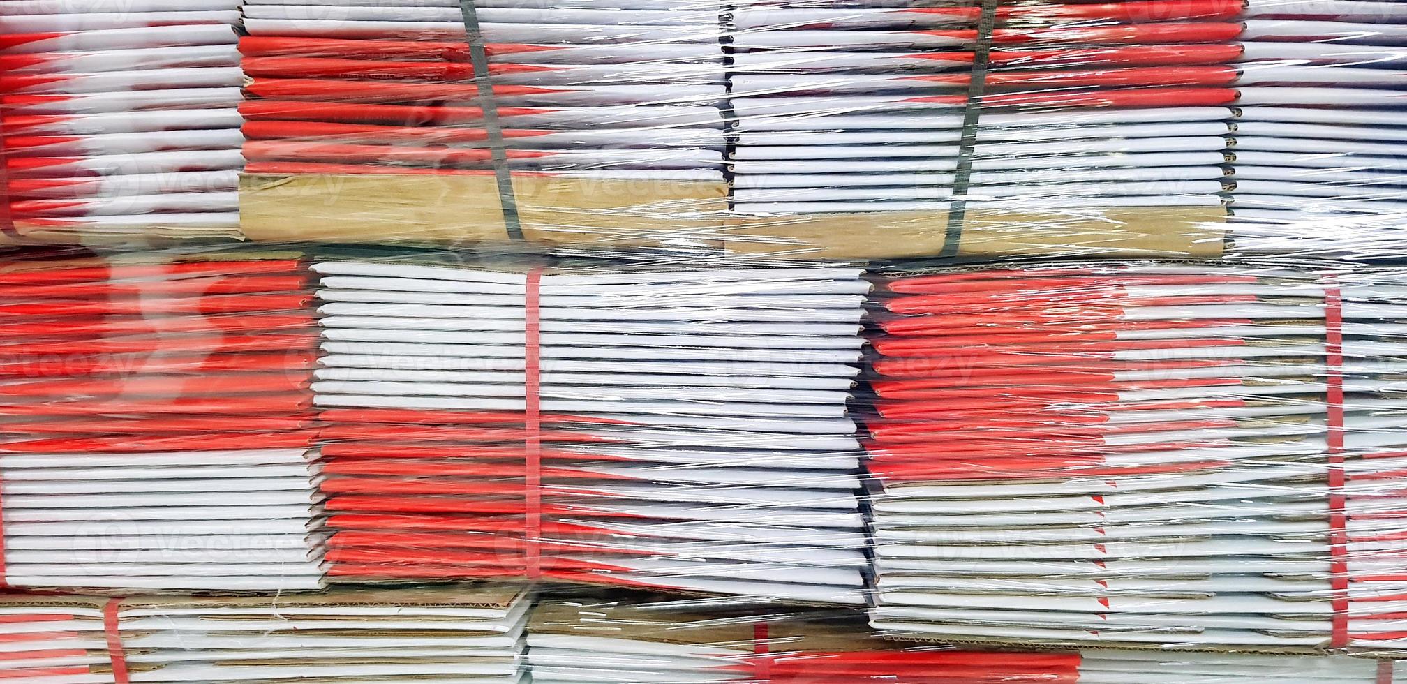 Pattern of red with white paper box for container parcel stacking and wrapping by plastic for background. Art wallpaper and Group of object concept photo