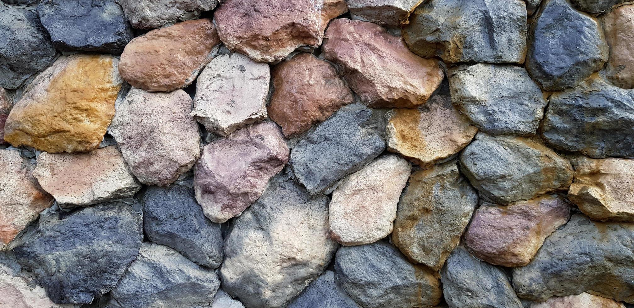 Colorful of big rock or stone wall for background. Group of object, Pattern wallpaper and Cracked concept photo