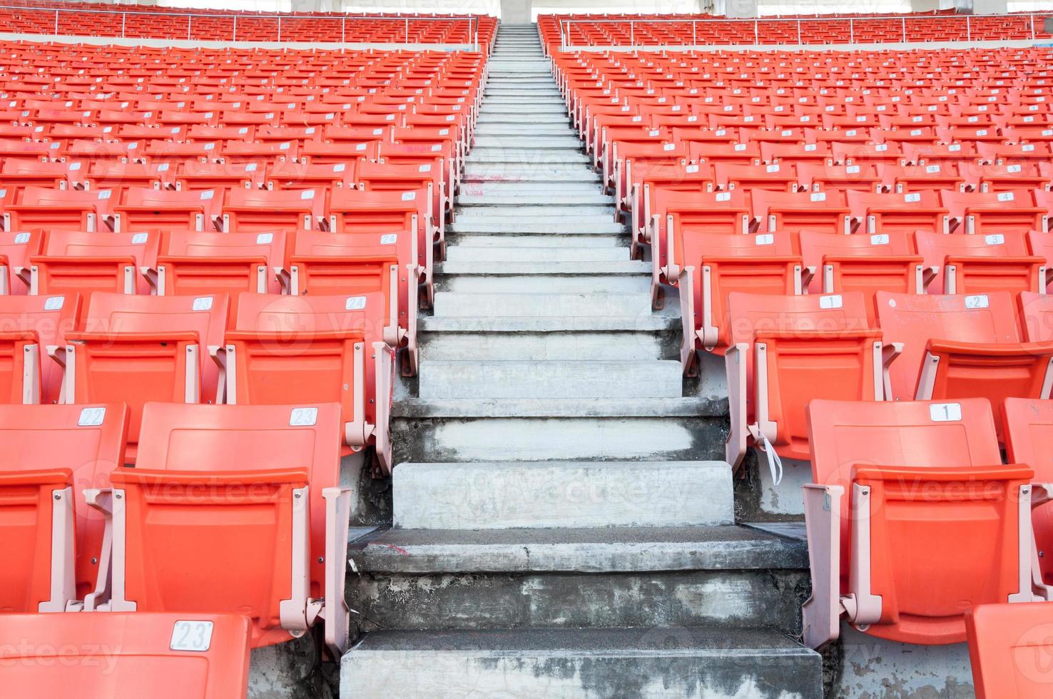 Empty orange seats at stadium,Rows of seat on a soccer stadium photo