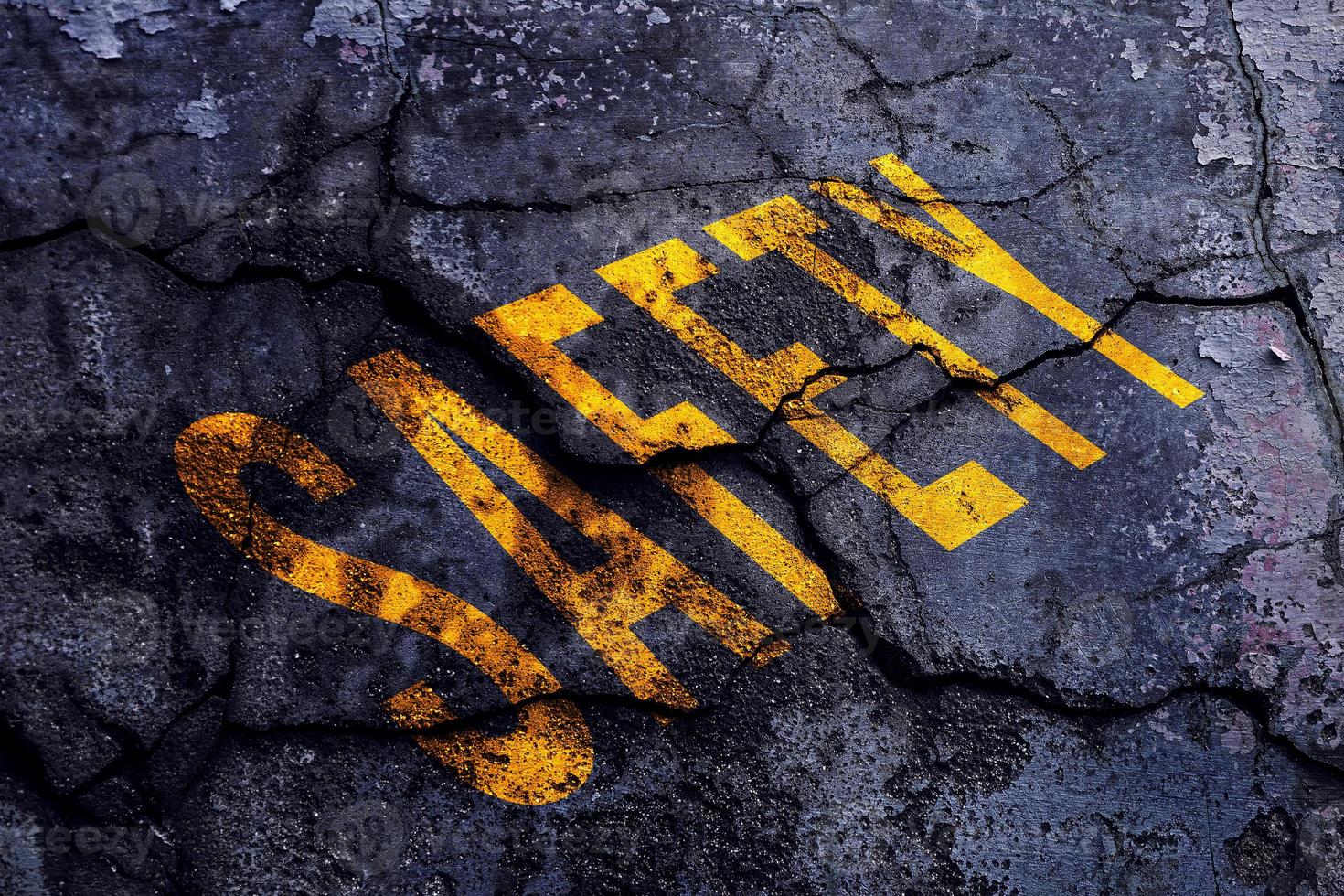 Safety first text written with broken cement wall, Safety first word on street. photo