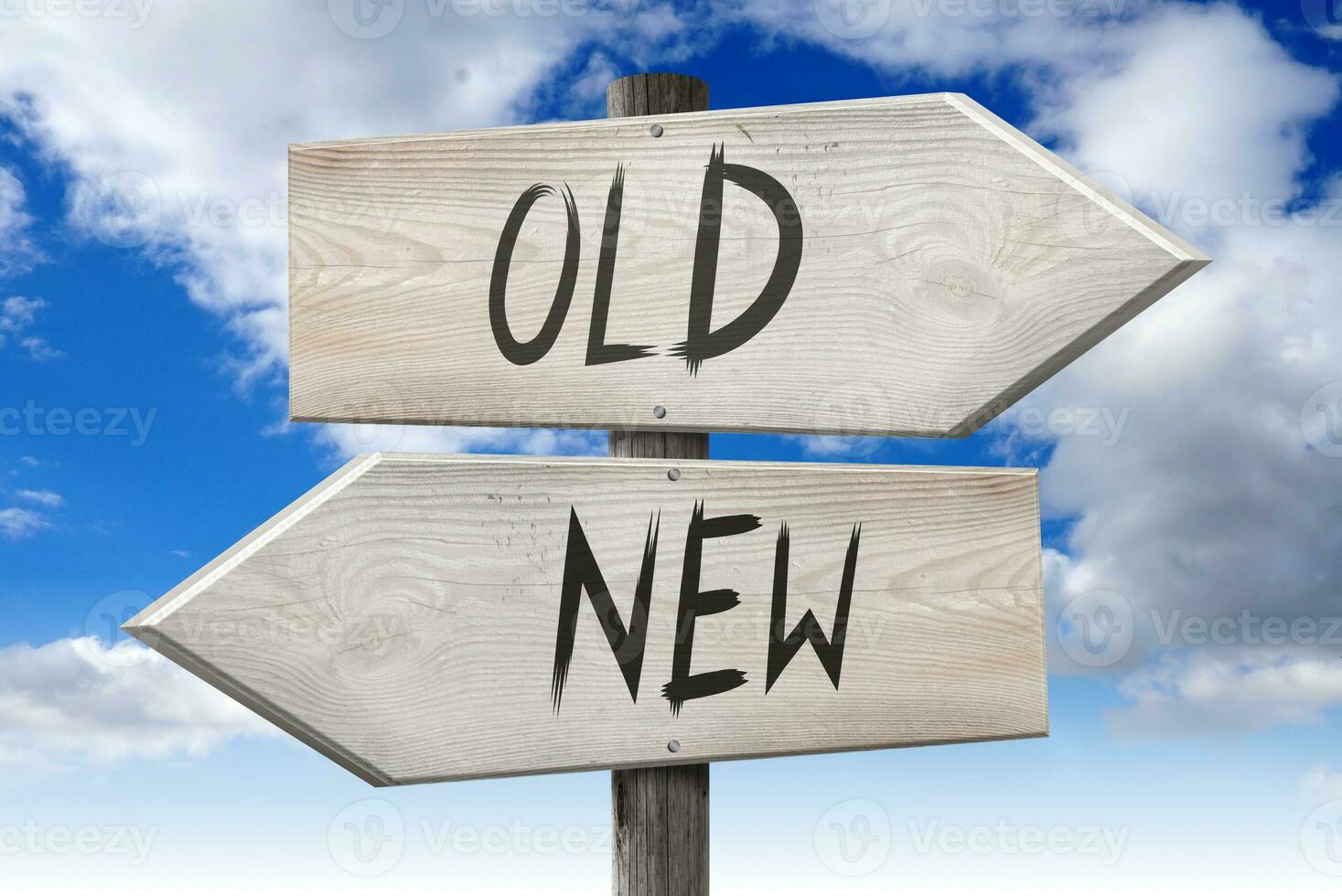 New, Old - Wooden Signpost with Two Arrows and Cloudy Sky in Background photo