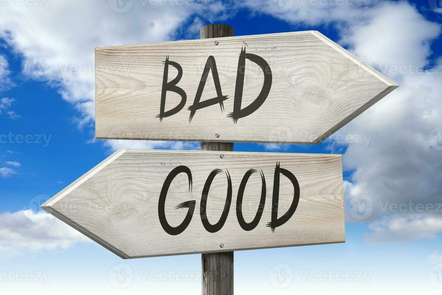 Good, Bad - Wooden Signpost with Two Arrows and Cloudy Sky in Background photo