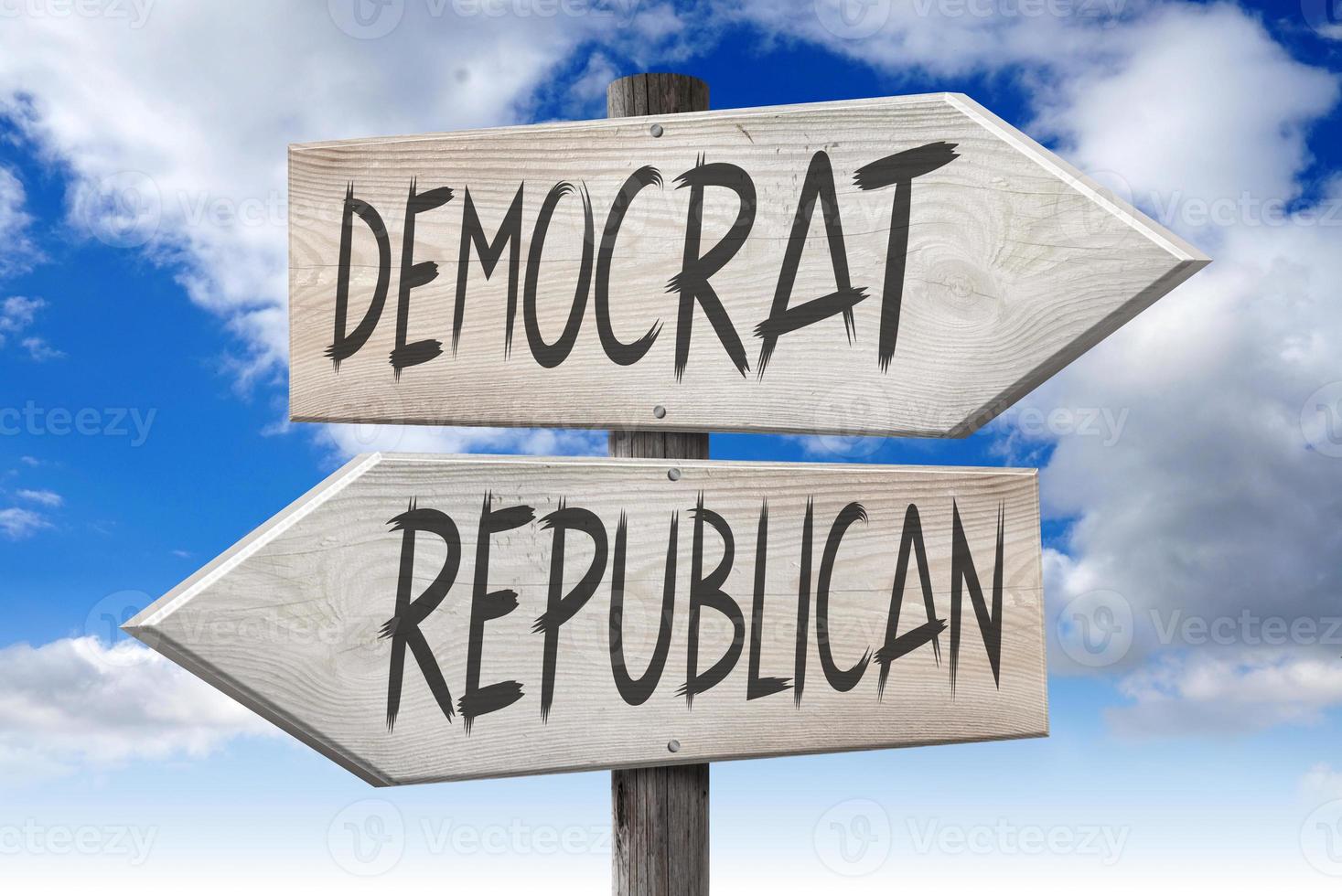 Democrat, Republican - Wooden Signpost with Two Arrows and Cloudy Sky in Background photo