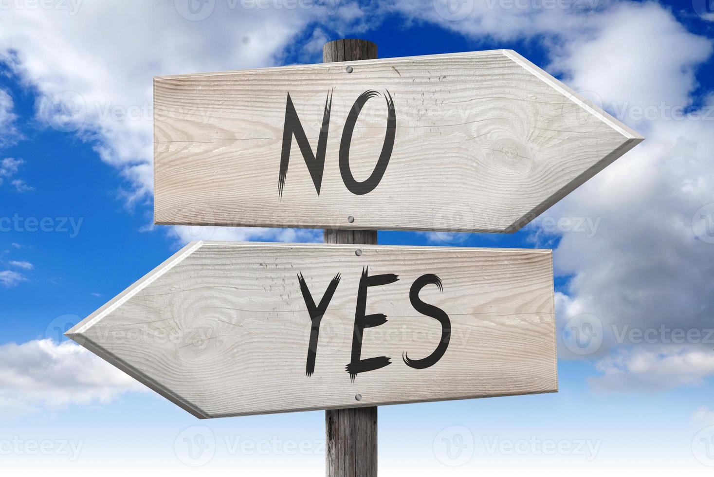 Yes, No - Wooden Signpost with Two Arrows and Cloudy Sky in Background photo