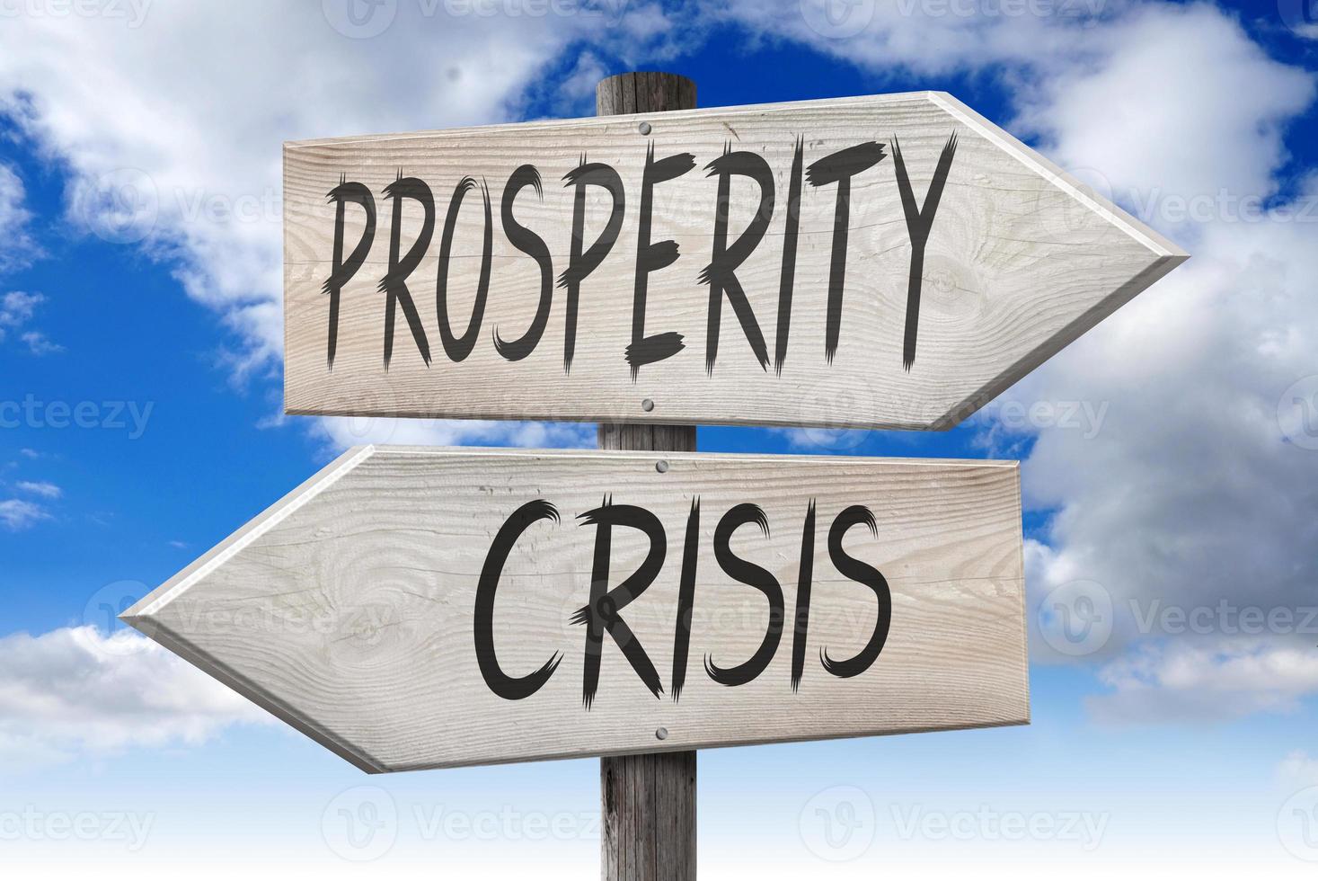 Prosperity, Crisis - Wooden Signpost with Two Arrows and Cloudy Sky in Background photo