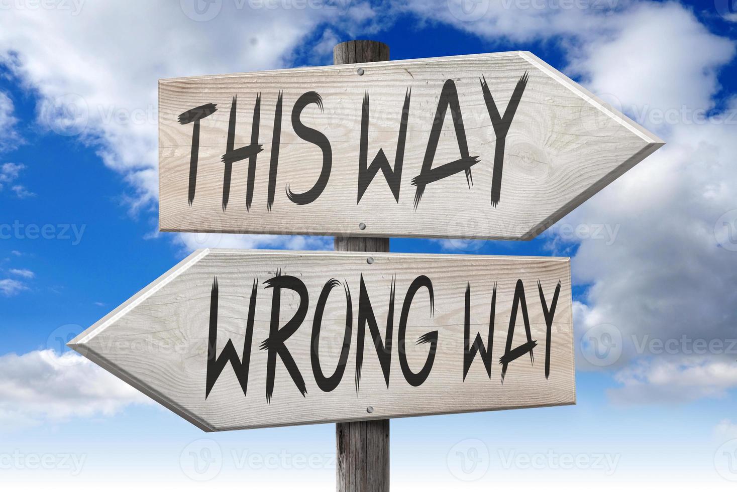 This Way, Wrong Way - Wooden Signpost with Two Arrows and Cloudy Sky in Background photo
