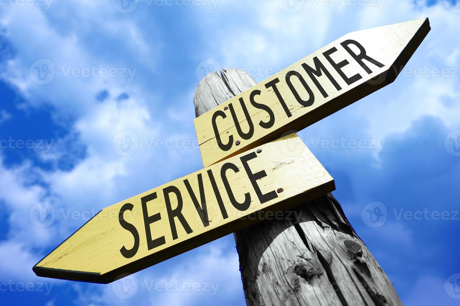 Customer Service - Wooden Signpost with Two Arrows and Sky in Background photo