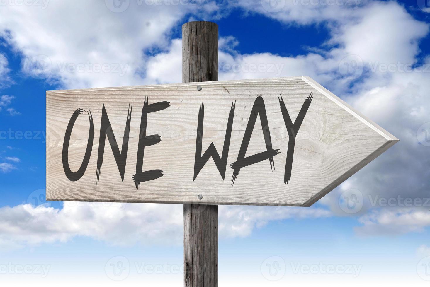 one Way - Wooden Signpost with one Arrow and Cloudy Sky in Background photo