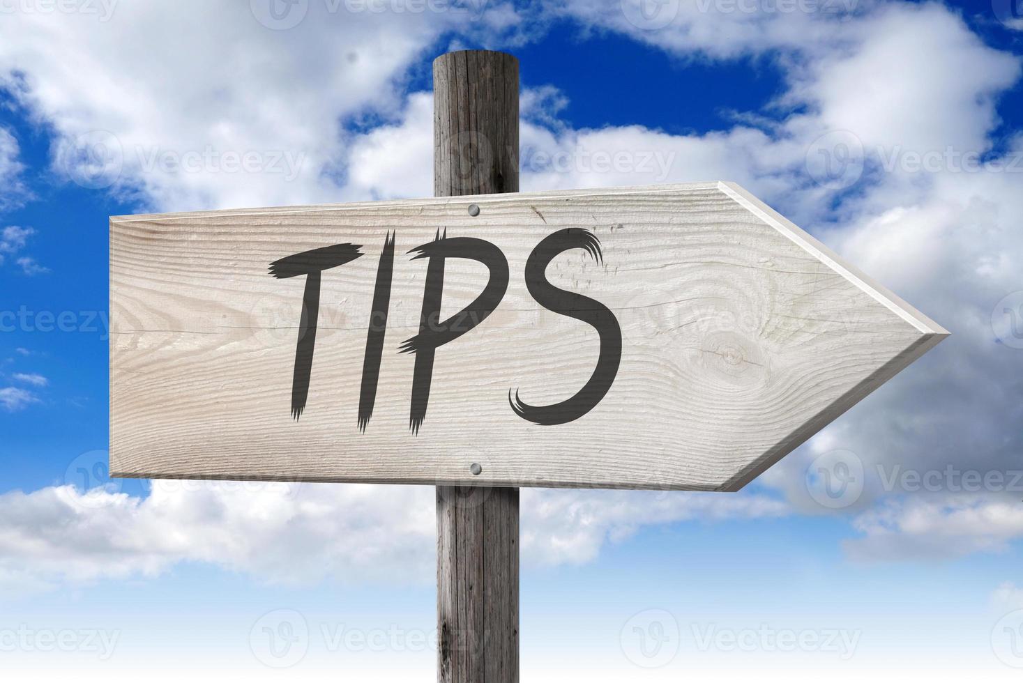 Tips - Wooden Signpost with one Arrow and Cloudy Sky in Background photo