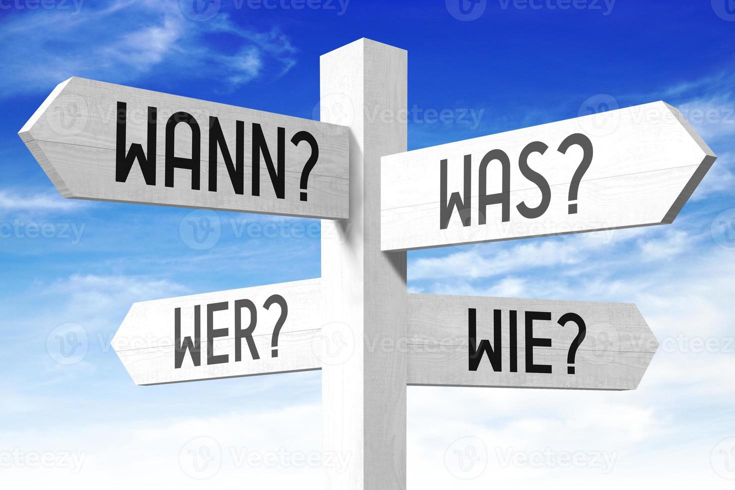 When, What, Who, How Questions in German - Wooden Signpost with Four Arrows and Sky in Background photo