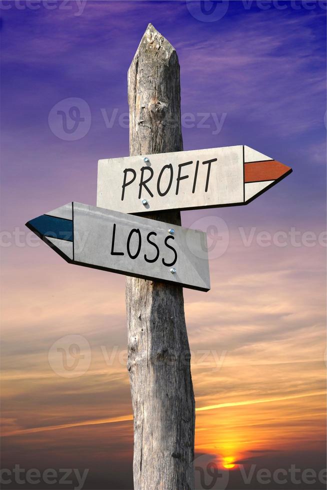 Profit and Loss - Signpost with Two Arrows, Sunset Sky in Background photo