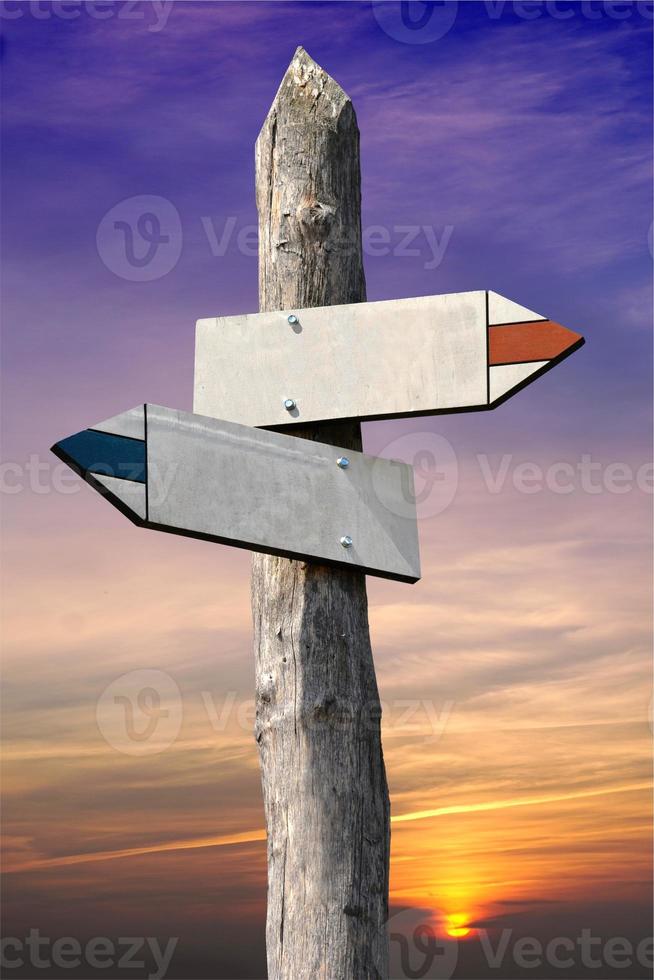 Empty Wooden - Signpost with Two Arrows, Sunset Sky in Background photo