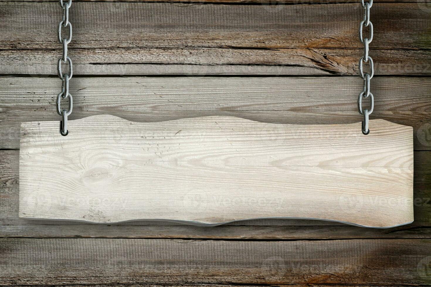 Empty Wooden Board Hanging on Chains with Wood in Background photo