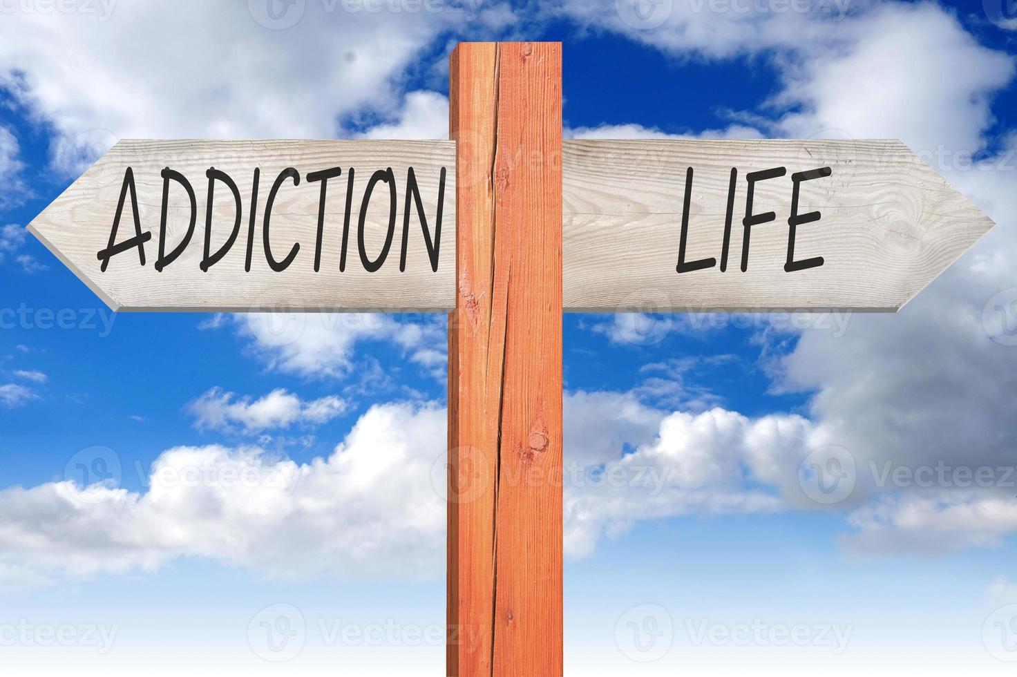 Addiction or Life - Wooden Signpost with Two Arrows and Cloudy Sky photo