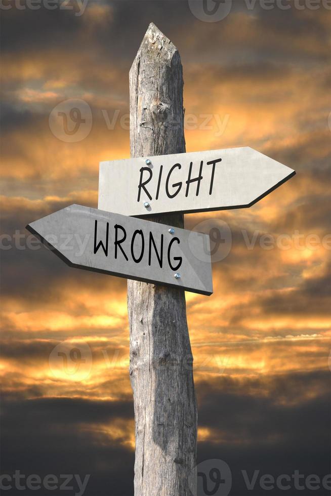 Right or Wrong - Wooden Signpost with Two Arrows and Sunset Sky photo