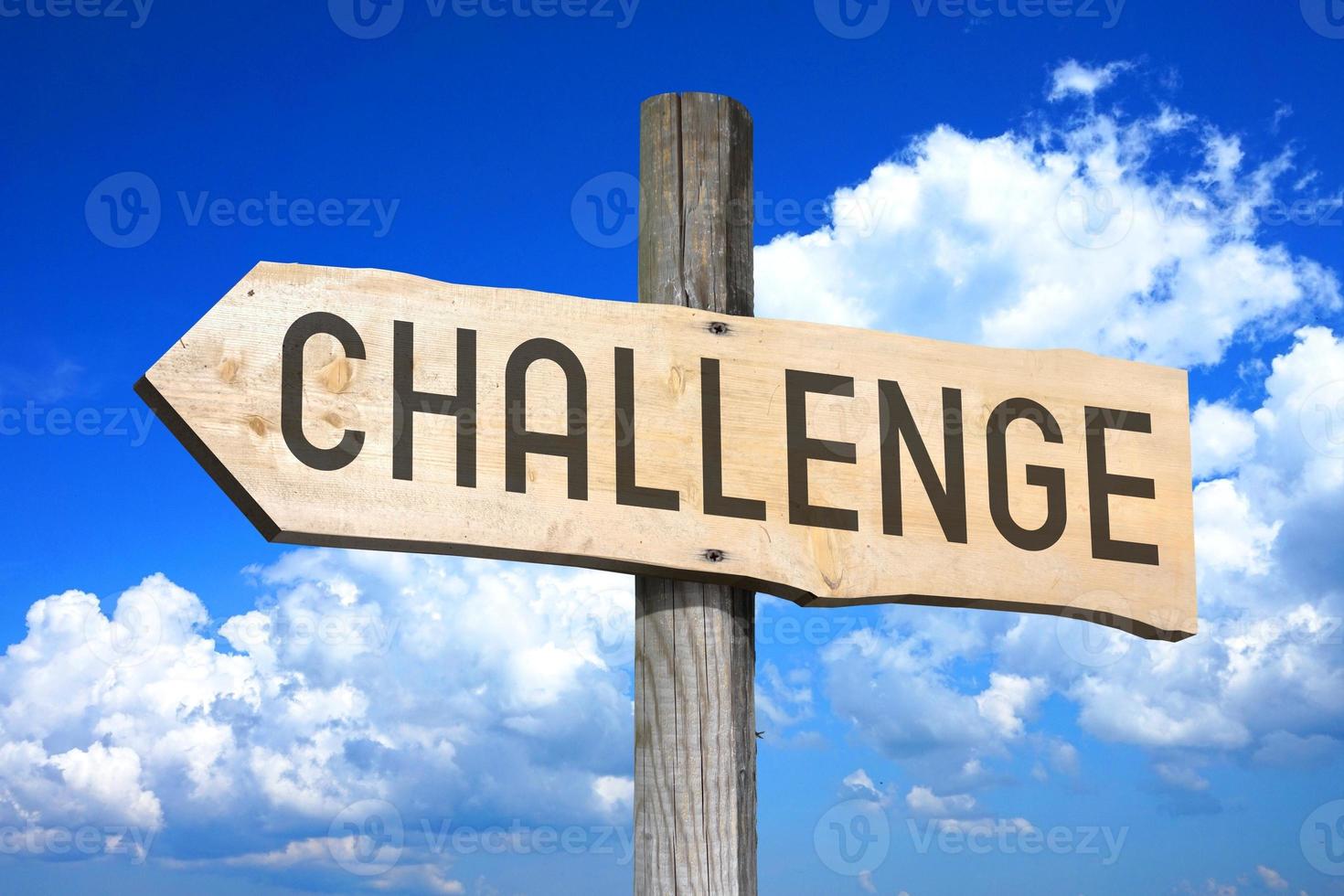 Challenge - Wooden Signpost with one Arrow, Sky with Clouds in Background photo