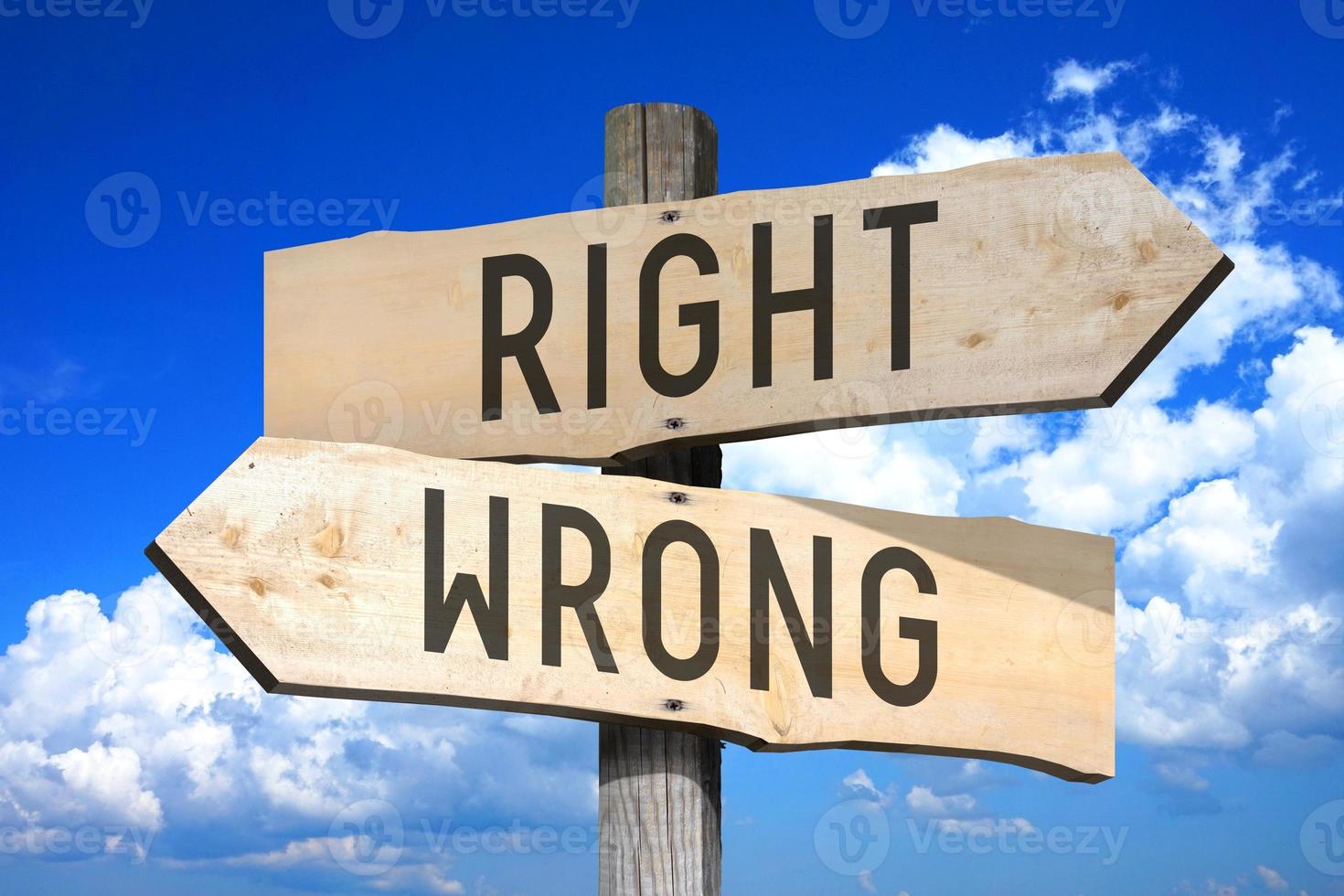 Right, Wrong - Wooden Signpost with Two Arrows, Sky with Clouds in Background photo