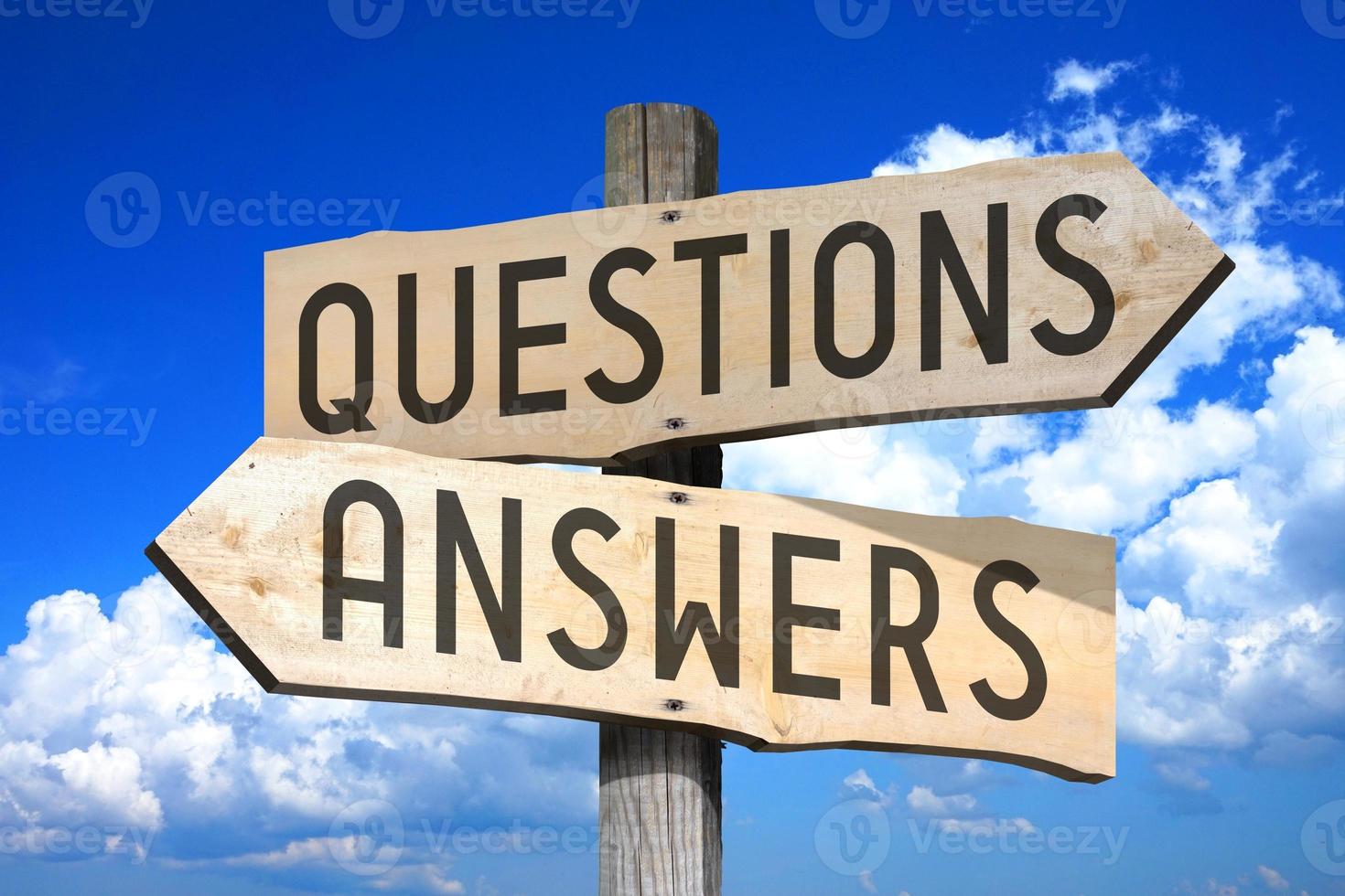 Questions, Answers - Wooden Signpost with Two Arrows, Sky with Clouds in Background photo