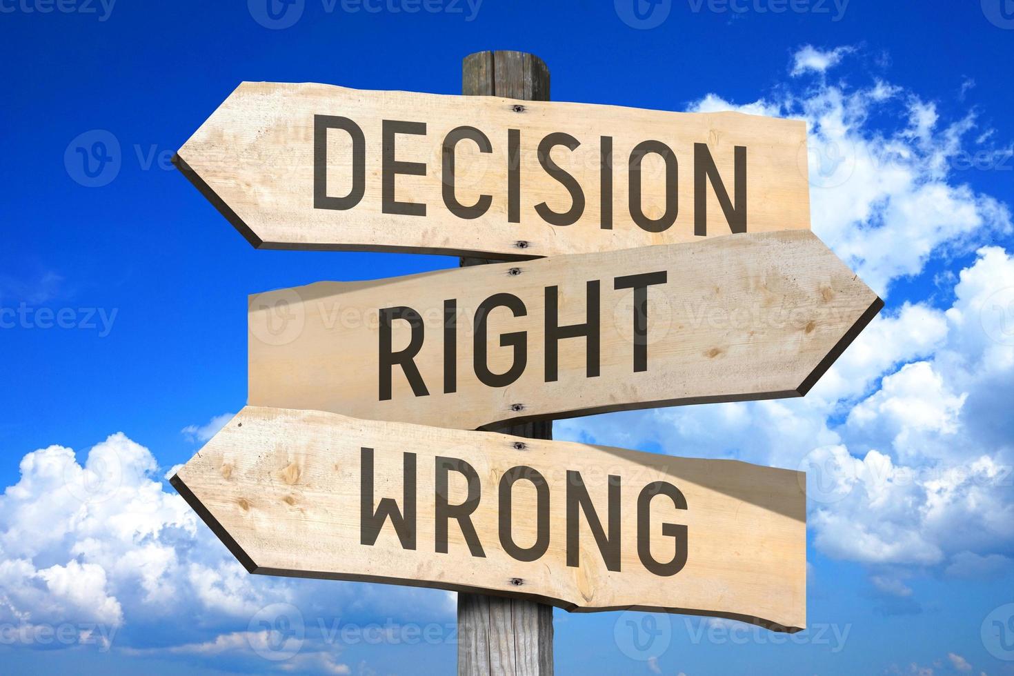 Decision Right or Wrong - Wooden Signpost with Three Arrows, Sky with Clouds in Background photo