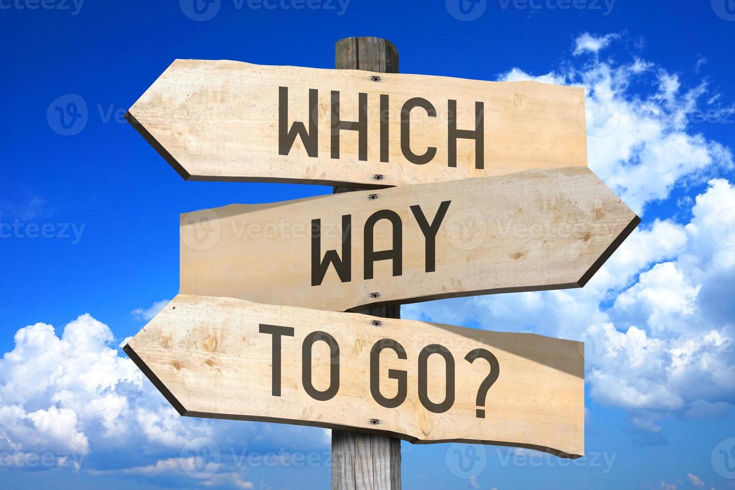 Which Way To Go - Wooden Signpost with Three Arrows, Sky with Clouds in Background photo