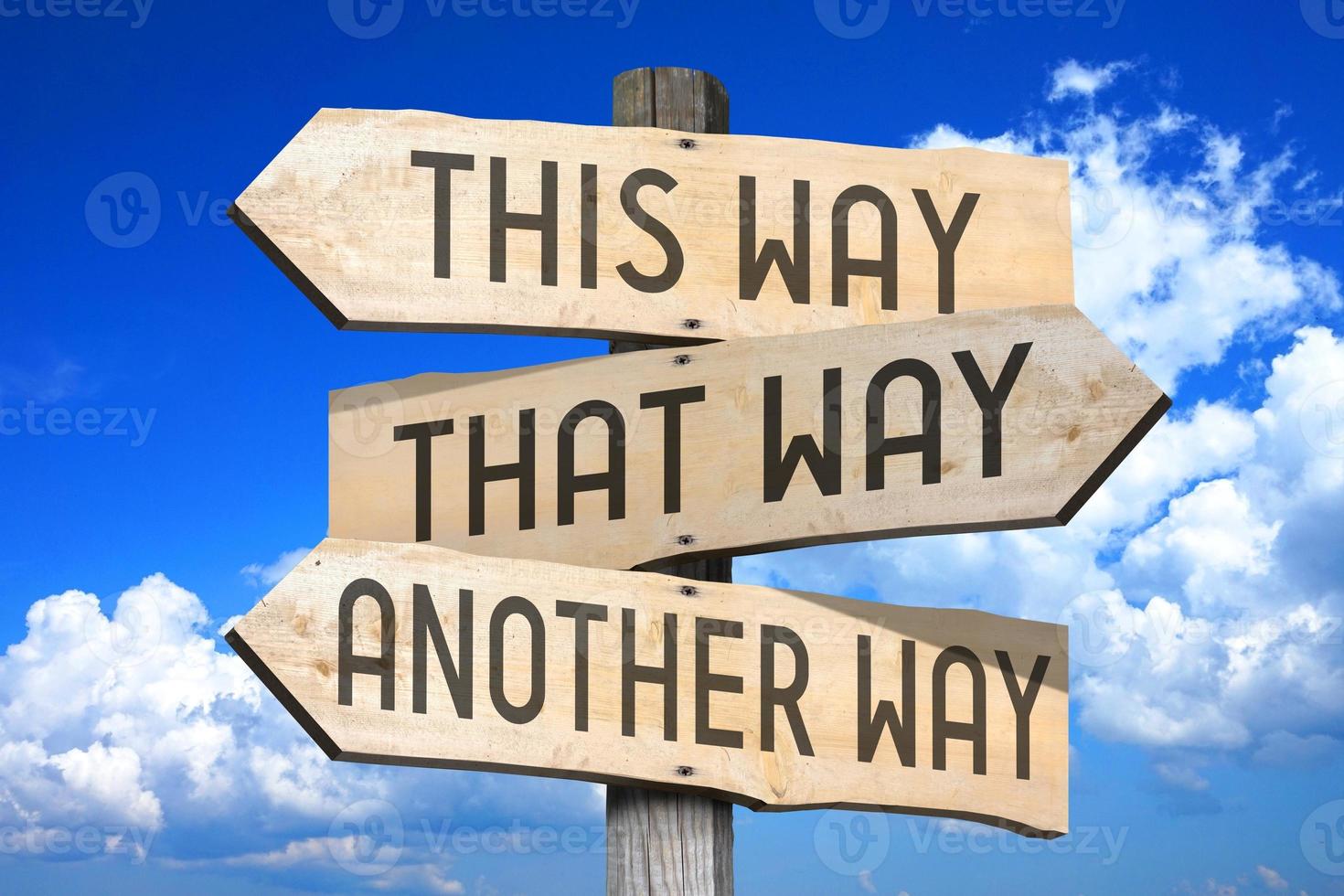 This Way, That Way, Another Way - Wooden Signpost with Three Arrows photo