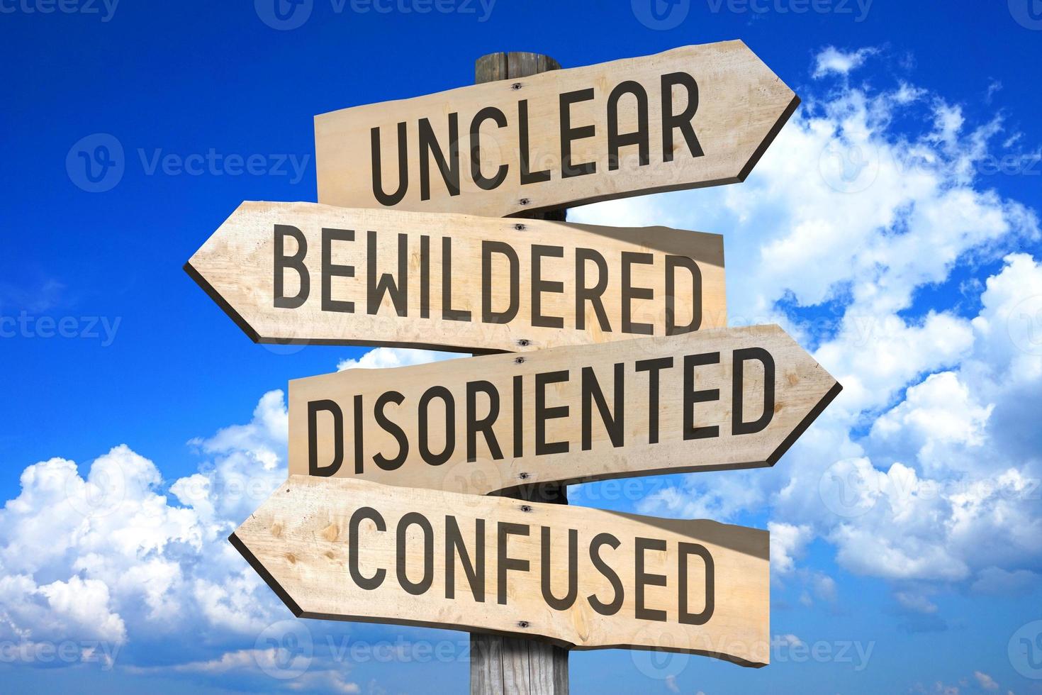 Unclear, Bewildered, Disoriented, Confused - Wooden Signpost with Four Arrows photo