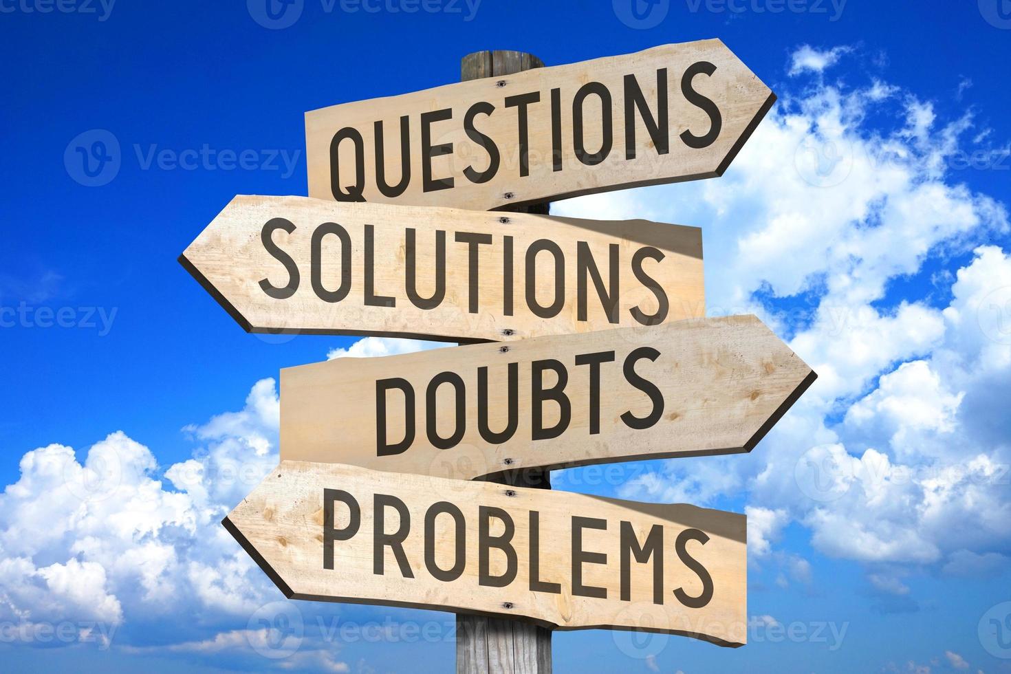 Questions, Solutions, Doubts, Problems - Wooden Signpost with Four Arrows, Sky with Clouds in Background photo