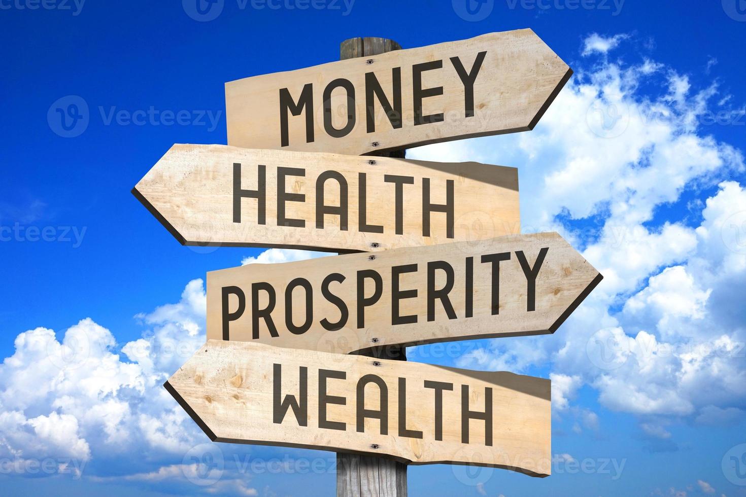 Money, Health, Prosperity, Wealth - Wooden Signpost with Four Arrows, Sky with Clouds in Background photo