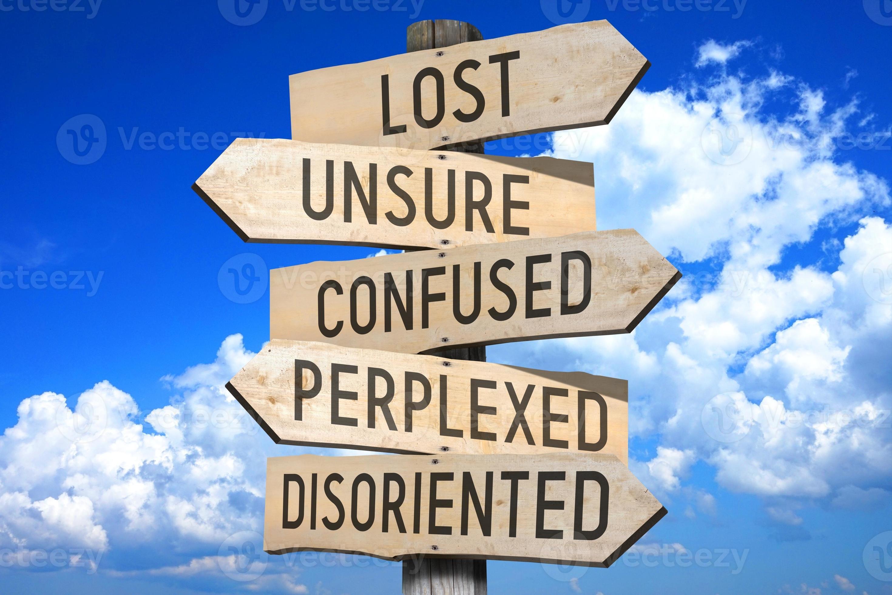 Lost Unsure Confused Perplexed Disoriented Wooden Signpost With lost-unsure-confused-perplexed-disoriented-wooden-signpost-with