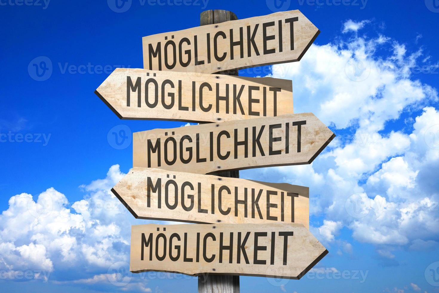 Option in German - Wooden Signpost with Five Arrows, Sky with Clouds in Background photo