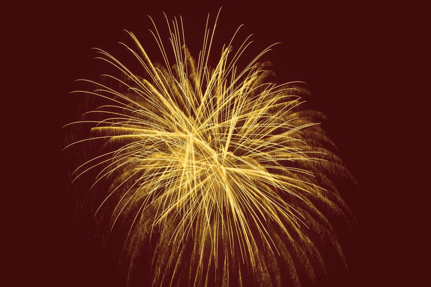 ellow fireworks against dark red background photo