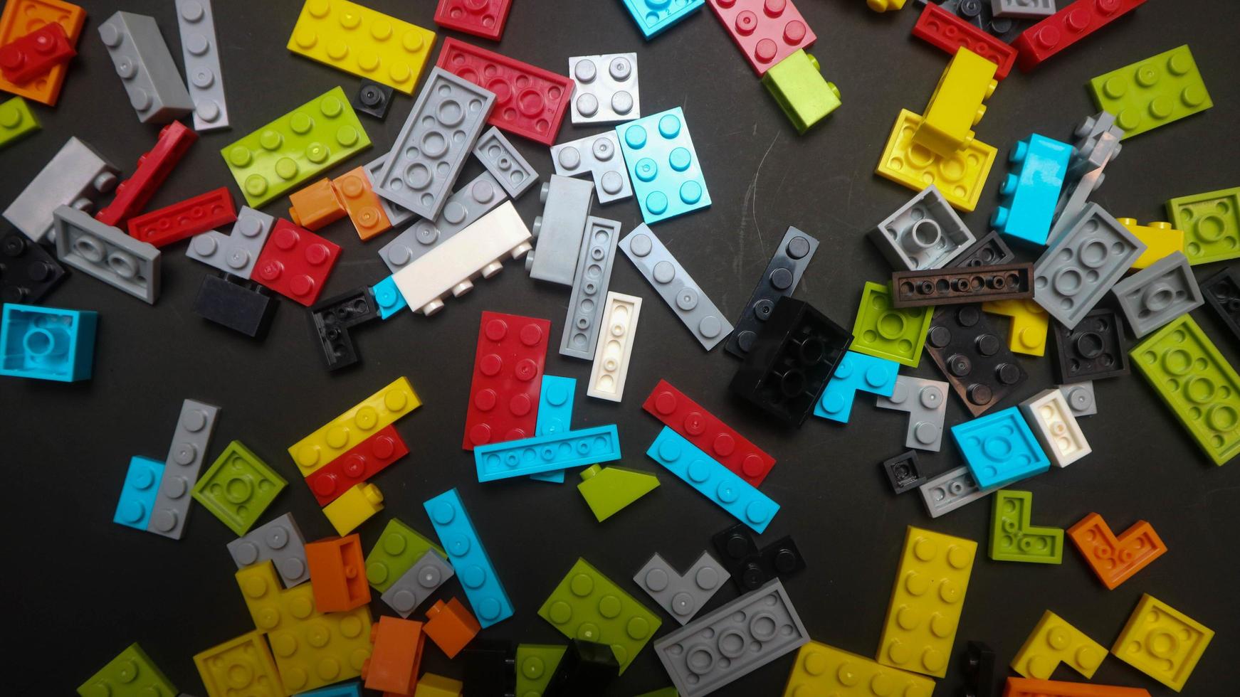 Plastic toy block on a black background photo